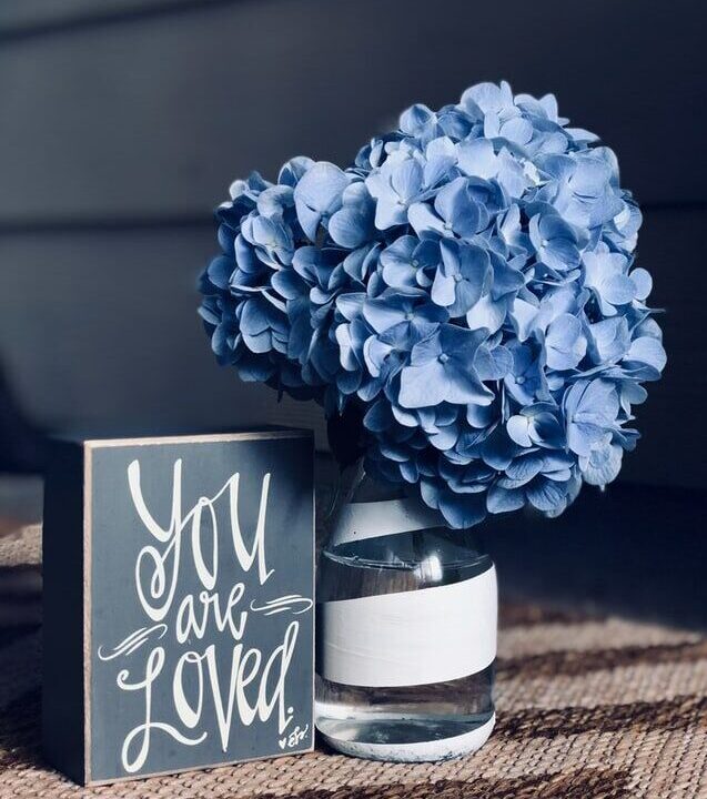 Sign with flowers, you are loved