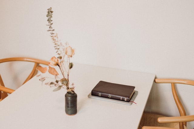 Bible with flowers on table