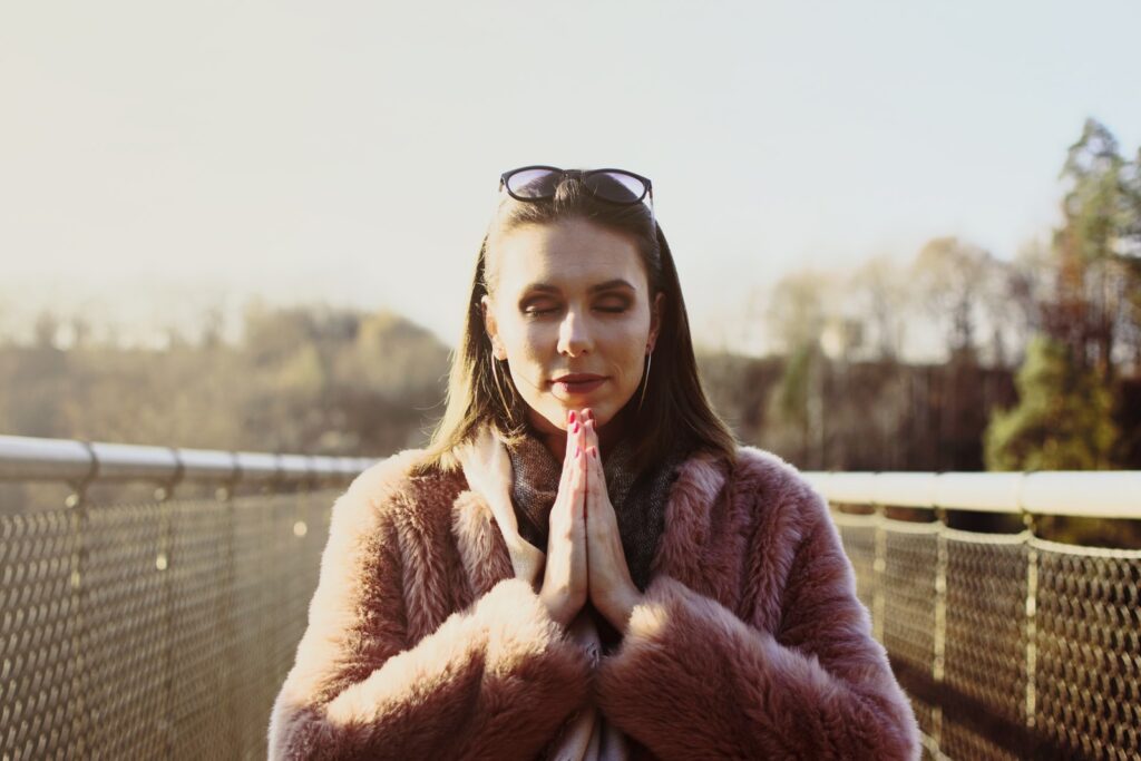 PRAYING THROUGH AN OVERWHELMED HEART, woman in brown fur coat wearing black framed eyeglasses