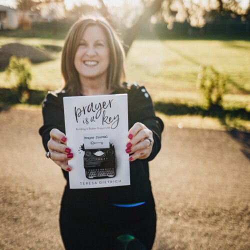 Author Teresa Dietrich holding her book Prayer Is A Key