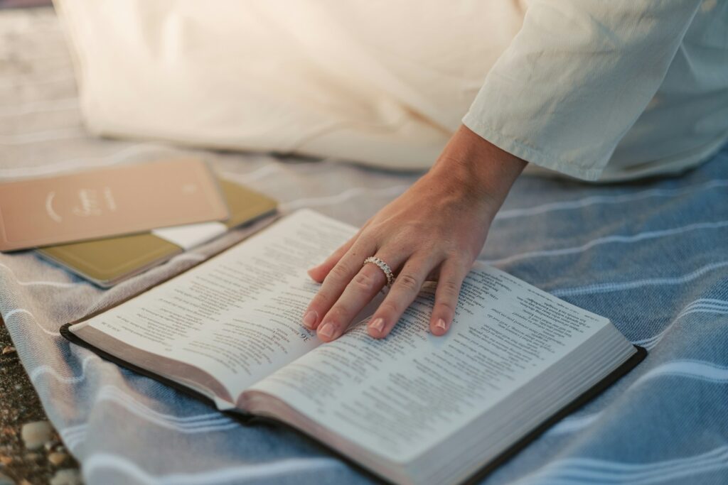 Read scripture when you can't pray, a woman is reading a bible on a bed